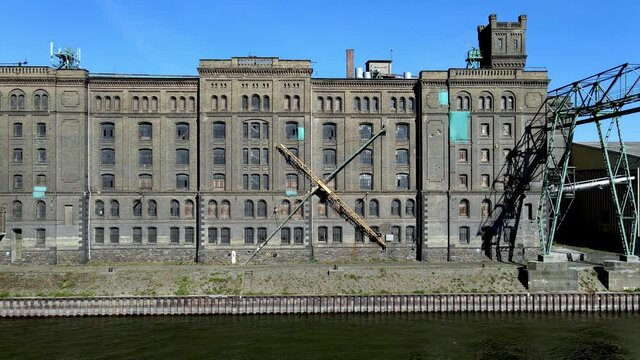 Aerial drone shot of industrial building along the Rhine River in Lahnstein, Germany.