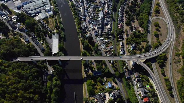 Aerial drone shot of cars driving on overpass over the Rhine River in Lahnstein, Germany.