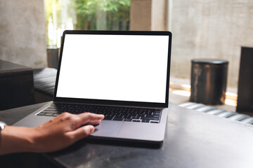 Mockup image of a woman using and touching on laptop touchpad with blank white desktop screen