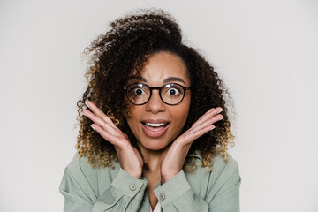 A portrait of a surprised woman with wide open eyes in the studio