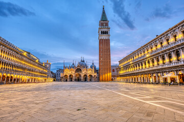 Fototapeta na wymiar An empty St Marks square in Venice with the bell tower and the cathedral at dawn