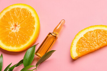 Ampule with vitamin C injection and orange fruit slices on color background