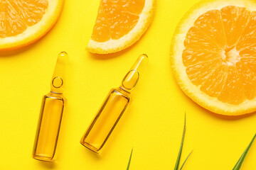 Ampules with vitamin C injection and orange fruit slices on color background - obrazy, fototapety, plakaty