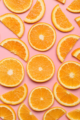 Slices of fresh oranges on color background