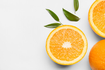 Fototapeta premium Fresh oranges with green leaves on white background
