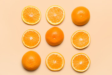 Pieces of fresh oranges on color background