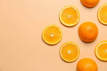 Pieces of fresh oranges on color background