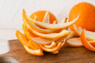 Board with fresh orange peel, closeup