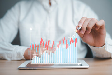 Businessman Analyzing business data in 2021, growth trends, next year's planning on virtual screen stock from the screen of digital tablet, development planning has a positive. Investment, finance.