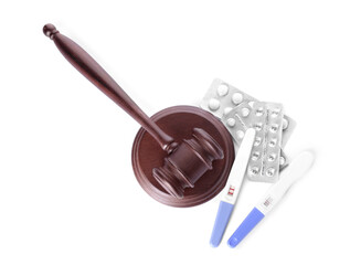 Judge gavel, pills and pregnancy tests on white background. Concept of health care reform