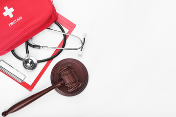 Judge gavel, stethoscope, clipboard and first aid kit on white background. Concept of health care...