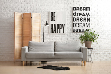 Interior of modern living room with sofa and folding screen