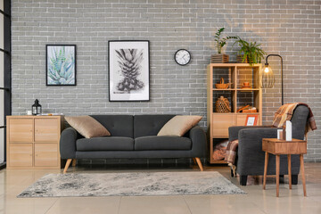 Interior of stylish living room with sofa and armchair