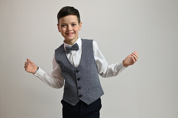 Portrait of a young guy with a smile in a suit with a bow tie on a white background