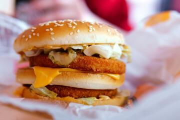 burger with chicken on the table of a fast food restaurant. close-up selective focus