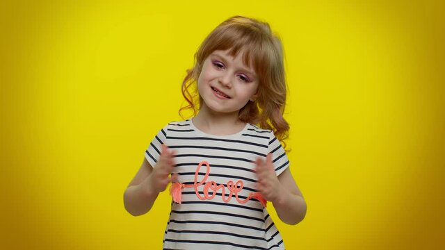 I am the best. Proud egoistic blonde kid child satisfied of her victory, bragging own success win achievements, pointing with smile fingers on herself. Teenager children girl on yellow wall background