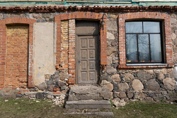 An old door and a new window in an old building..