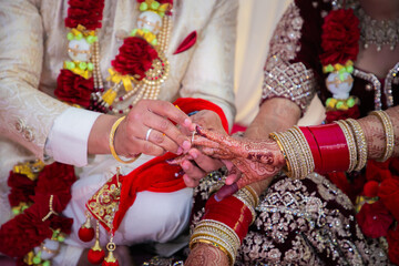 Fototapeta na wymiar Indian Punjabi wedding ceremony doli and pani varna, ritual items and hands close up
