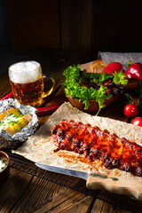 spicy spare ribs with baked potatoes and sour cream