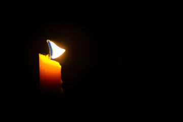 Lighted candle on a dark background, Light a candle for religious ceremony