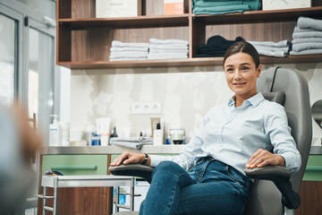 Contented female client waiting for a cosmetic procedure