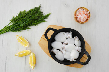 Overhead view of baby cuttlefish in cast iron skillet