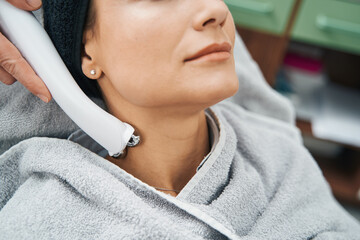 Beauty salon client undergoing a neck rejuvenation procedure