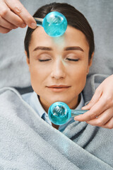 Female client napping during the facial massage - obrazy, fototapety, plakaty