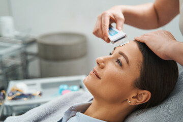 Spa client having her pores cleaned with an ultrasonic spatula