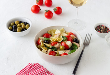 Pasta salad with tuna, tomatoes and white cheese. Farfalle. Healthy eating. Diet.