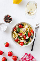 Pasta salad with tuna, tomatoes and white cheese. Farfalle. Healthy eating. Diet.