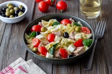 Pasta salad with tuna, tomatoes and white cheese. Farfalle. Healthy eating. Diet.