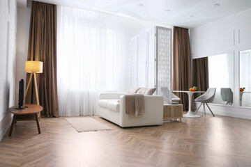 Modern living room with parquet floor and stylish furniture