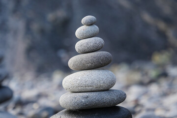 Stone piles made along a beach and the sea in the background. High quality photo