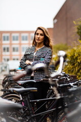 Woman on street with bike. Focus is on woman.