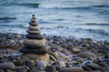 Stone piles made along a beach and the sea in the background. High quality photo