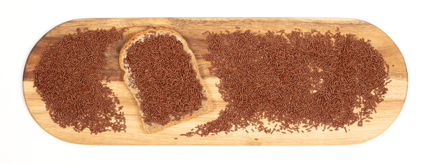 Typical dutch chocolate sprinkles (hagelslag) on a slice of bread, served on a wooden plate