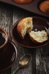 The concept of home baking. Fresh delicious muffins on the table.