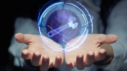 Female hands show a round conceptual hologram with adjustable wrench hand tool. Unrecognizable woman in ashen white on a black background with future holographic technology
