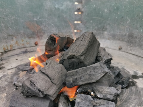 Macro view of burning coal embers bonfire, detail of coal texture