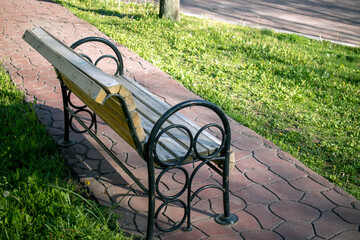 Bench standing empty in the park without people. pandemic process quarantine.