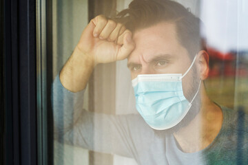 Close up of man in mask looking through the window