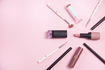 Beautiful cosmetic accessories on a pink background.