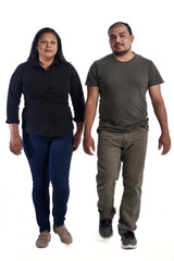 serious latin American couple walking in front