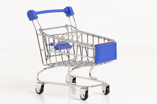 Empty shopping basket on colorful background. Shop trolley at supermarket. Sale, discount, shopaholism, black friday, economy concept. Consumer society trend. Sustainable lives. stock photo