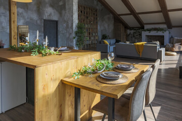 Dark loft style interior of big cozy country house. open plan apartment with kitchen area, rest zone and bed area. Huge windows and wooden decoration