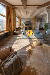 Dark loft style interior of big cozy country house. open plan apartment with kitchen area, rest zone and bed area. Huge windows and wooden decoration