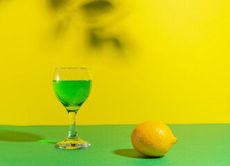 Modern still life with cool green drink in yellow green tones