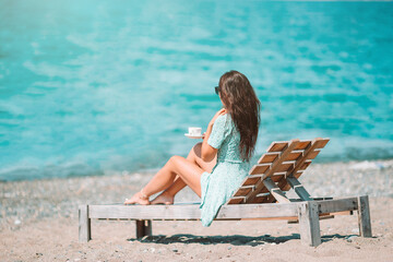 Young woman with cup of hot coffee enjoy holidays