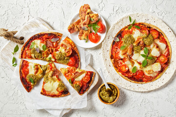 hot pizza with tomatoes, cheese, bacon, pesto